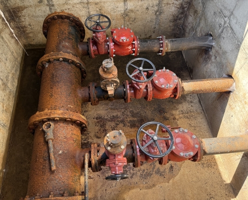Triplex valve vault with gate valves and piping