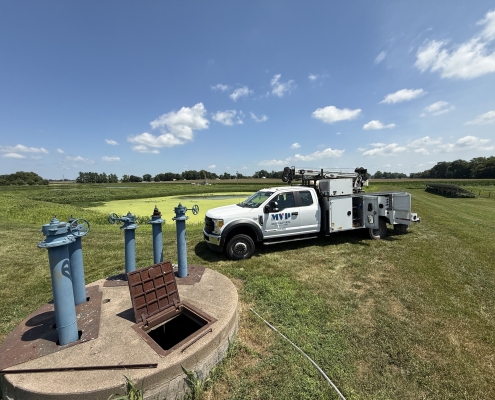 Mississippi Valley Pump service truck parked at a wellhead site under a blue sky